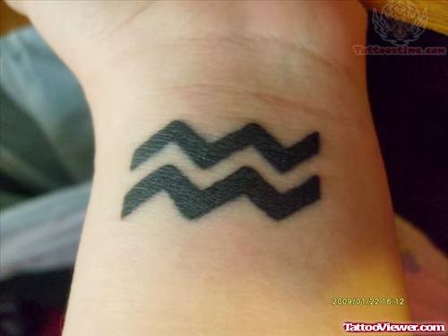 Attractive Black Aquarius Tattoo On Left Wrist