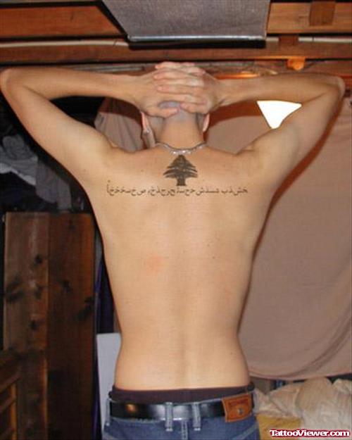 Man With Arabic Tattoo On Upperback