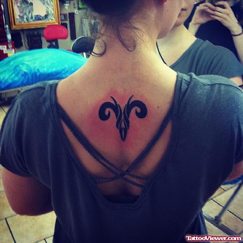 Black Ink Aries Tattoo On Upperback