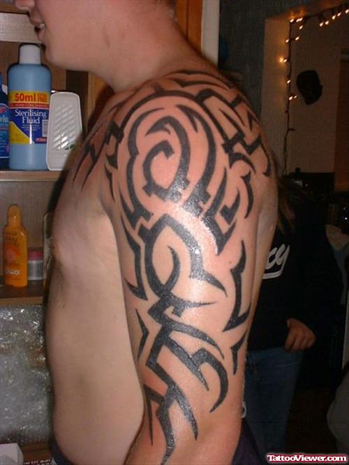 Unique Black Ink Tribal Tattoo On Left Arm