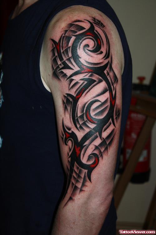 Red And Black Tribal Tattoo On Left Sleeve
