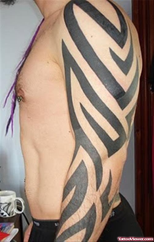 Black Ink Tribal Tattoo On Left Arm