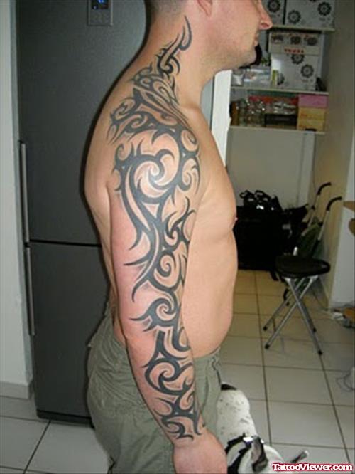Stylish Black Ink Tribal Tattoo On Man Right Arm