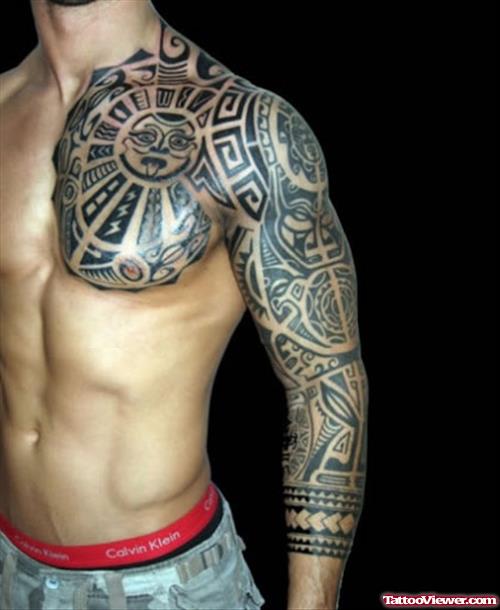 Maori Tattoo On Man Chest And Left Arm