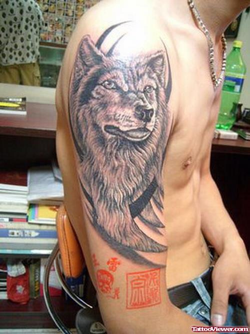 Grey Ink Tribal And Wolf Arm Tattoo