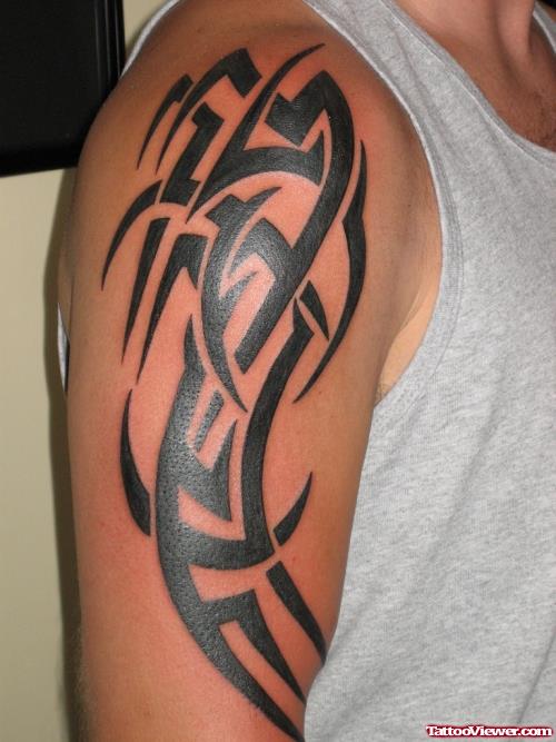Impressive Black Ink Tribal Tattoo On Man Right Arm