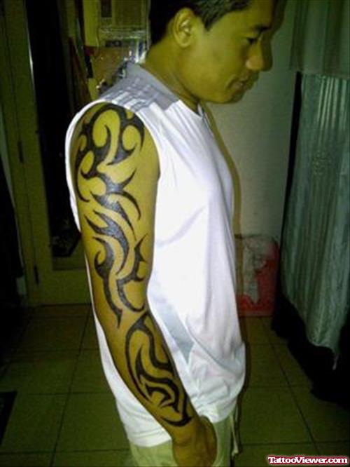 Black Ink Tribal Tattoo On Man Right Arm
