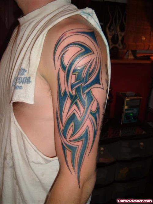 Blue Ink Tribal Tattoo On Sleeve