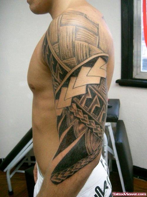 Awesome Grey Ink Polynesian Tattoo On Man Left Arm