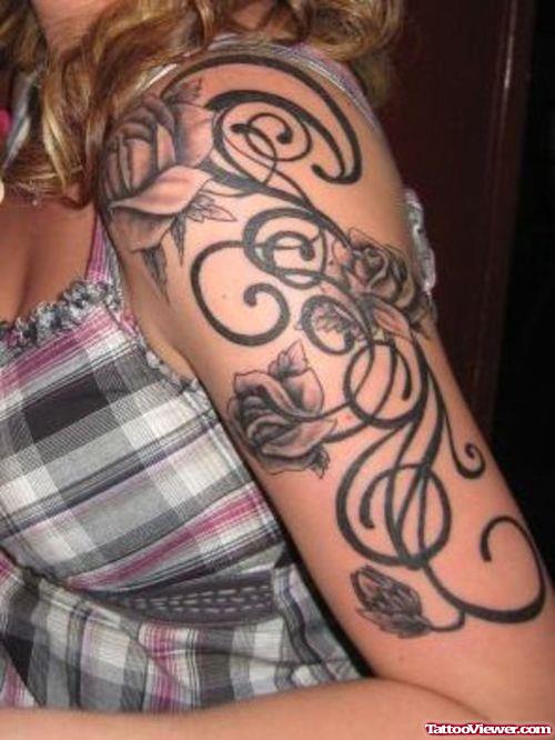 Grey Ink Flowers And Tribal Arm Tattoo