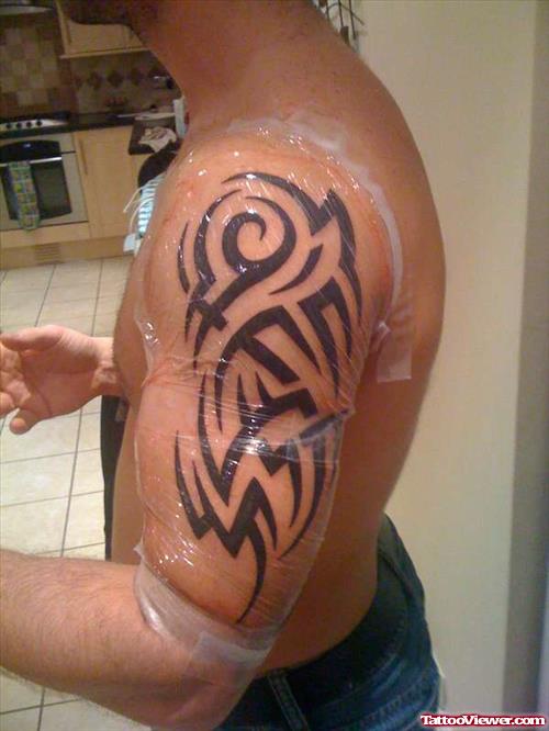 Black Ink Tribal Arm Tattoo For Men
