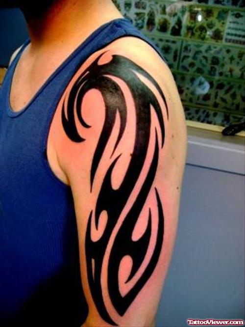 Attractive Black Ink Tribal Tattoo On Man Left Arm