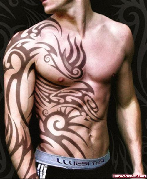 Black Ink Tribal Tattoo On Arm And Chest