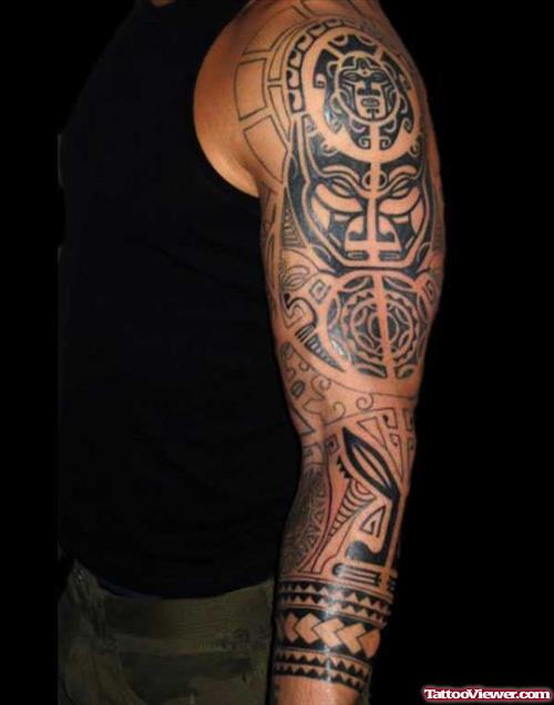Black Ink Maori Tattoo On Man Left Sleeve