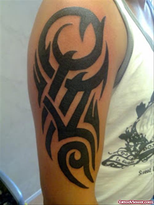 Attractive Black Ink Tribal Tattoo On Man Right Sleeve