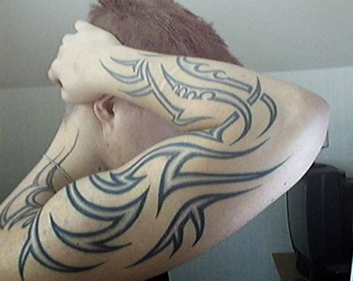 Black Ink Tribal Tattoo On Right Arm For Men