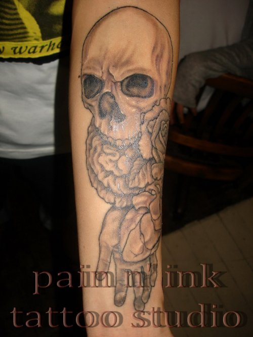 Grey Ink Skull Tattoo On Left Arm