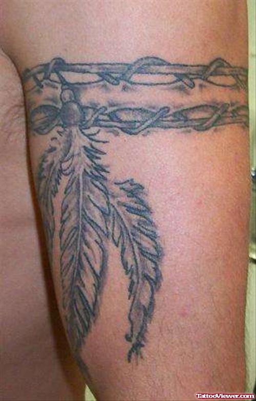 Grey Ink Feather And Barbed Wire Armband Tattoo On Half Sleeve