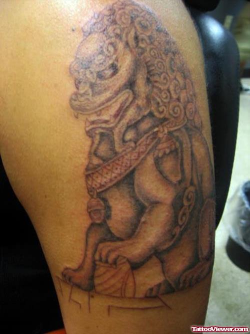 Grey Ink Asian Foo Dog Tattoo On Bicep