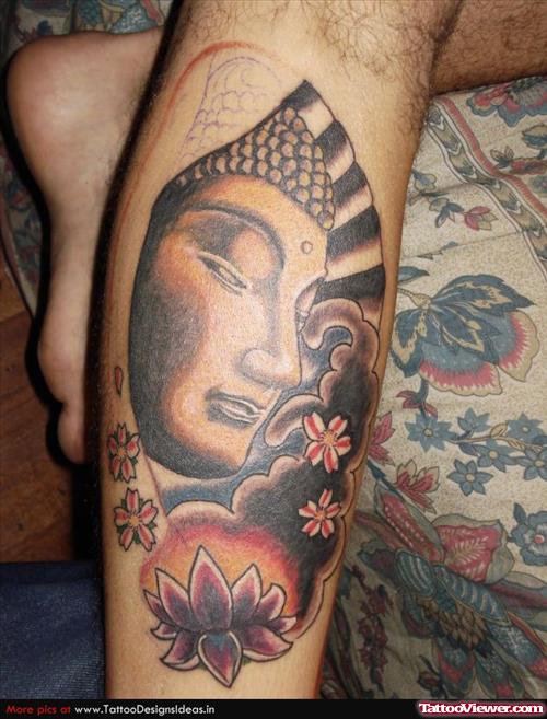 Asian Lotus Flower And Buddha Head Tattoo On Leg
