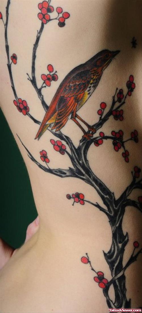 Asian Flowers And Bird Tattoo On Side Rib