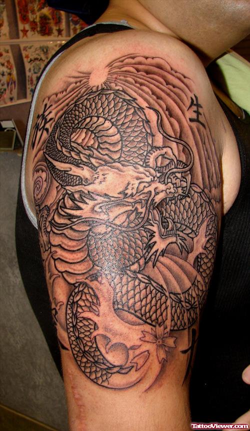 Grey Ink Asian Tattoo On Bicep
