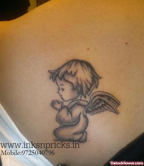 Grey Ink Praying Baby Angel Tattoo On Back