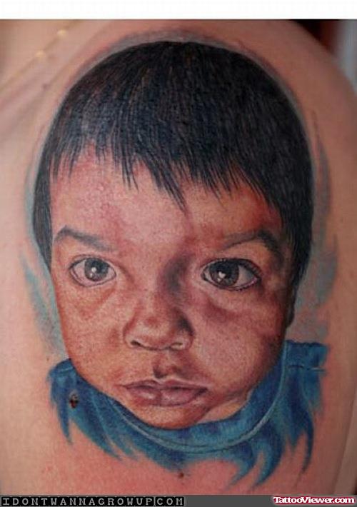 Blue Ink Baby Head Tattoo