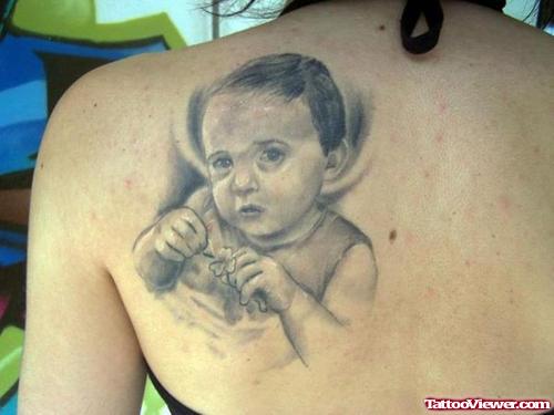 Attractive Grey Ink Baby Tattoo On Left Back Shoulder