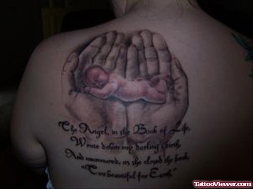 Small Baby In Hands Tattoo On Back Shoulder