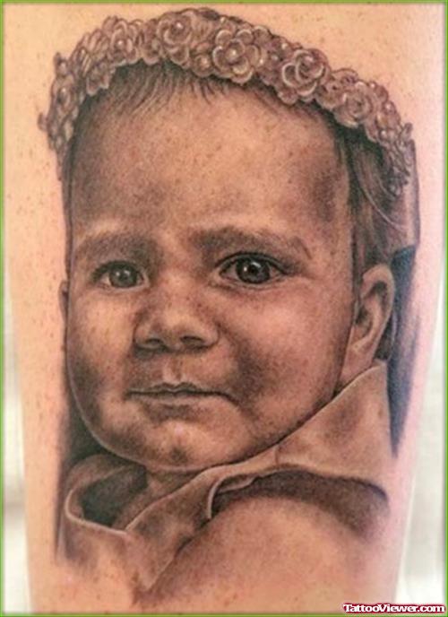 Grey Ink Baby Head Tattoo