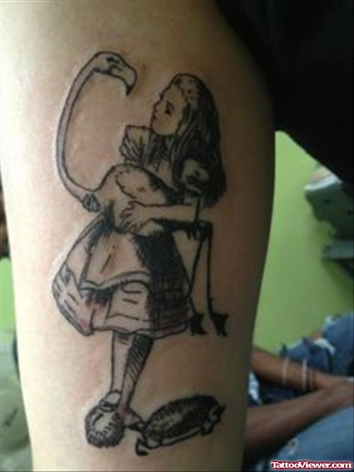 Grey Ink Baby Girl With Crane Tattoo On Arm