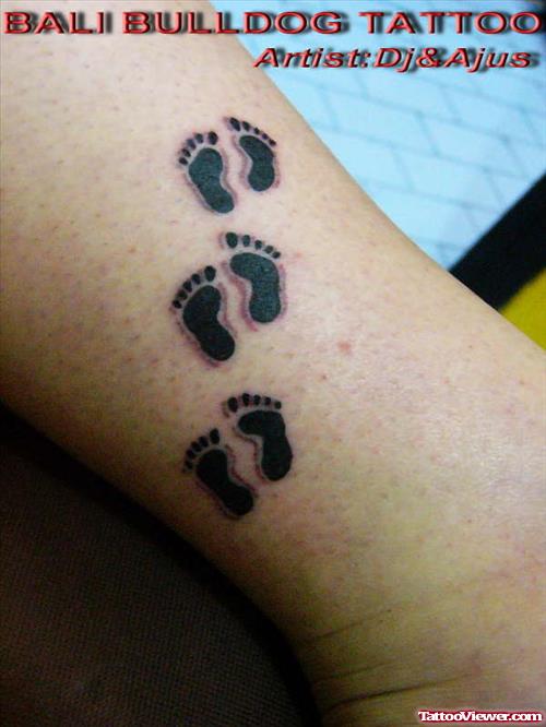 Black Ink Baby Footprints Tattoo On Ankle