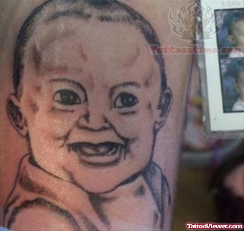 Grey Ink Smiling Baby Tattoo