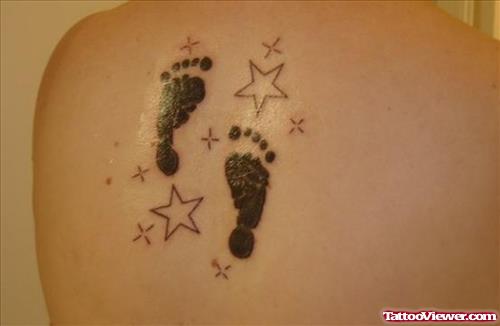 Outline Stars And Footprints Tattoo On Back Shoulder