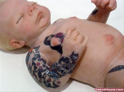 Black Ink Tattoo On Baby Arm And Chest