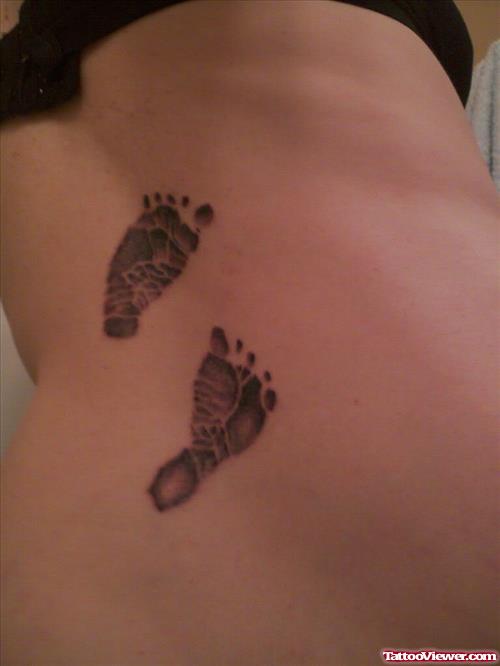 Awesome Grey Ink Baby Footprints Tattoos On Back