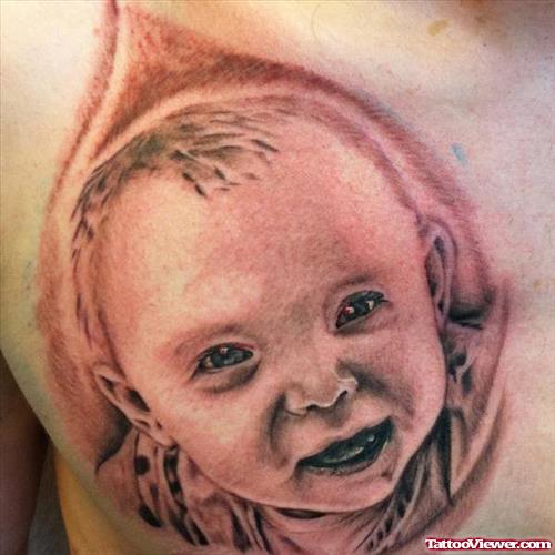 Smiling Baby Head Tattoo On Man Chest