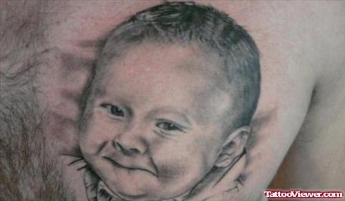 Grey Ink Baby Portrait Tattoo On Chest