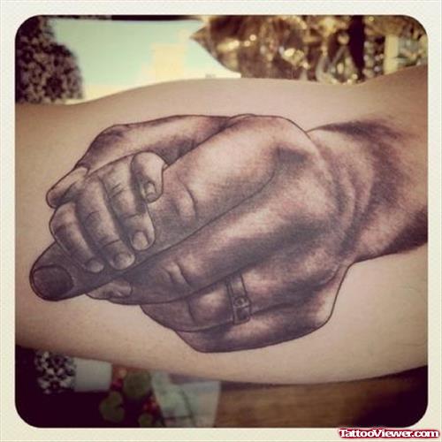Grey Ink Baby Hand Tattoo on Bicep