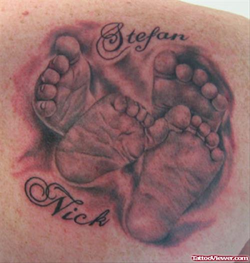 Grey Ink Baby Feets Tattoos On Back Shoulder