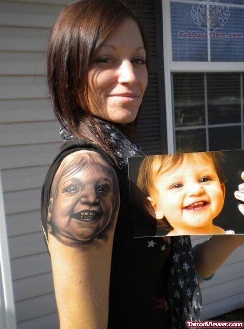 Smiling Baby Tattoo On Shoulder