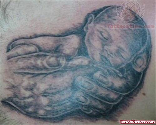 Baby In Hands Tattoo