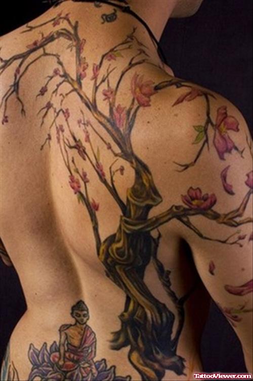 Flowers Tree And Buddha Sitting On Lotus Back Tattoo