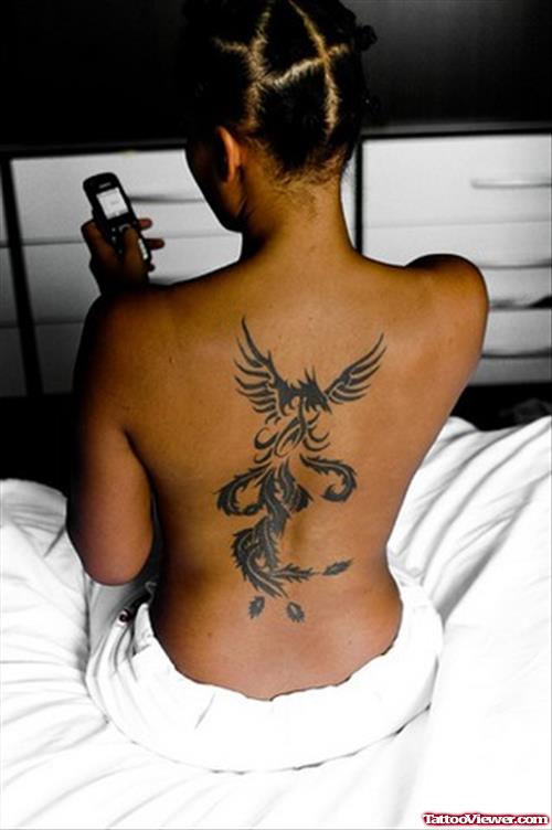 Tribal Phoenix Black Ink Back Tattoo For Girls