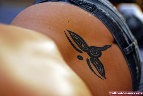 Tribal Eyes Lower Back Tattoo