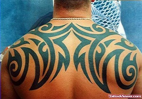 Attractive Black Ink Tribal Tattoo On Upperback