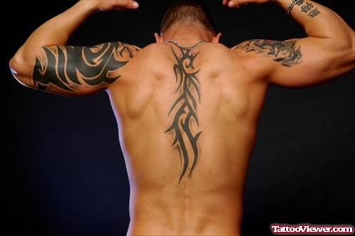 Amazing Black Ink Tribal Back Tattoo