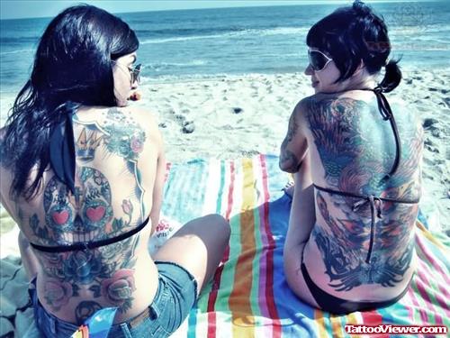 Surgar Skull and Phoenix Tattoos On Girl Back