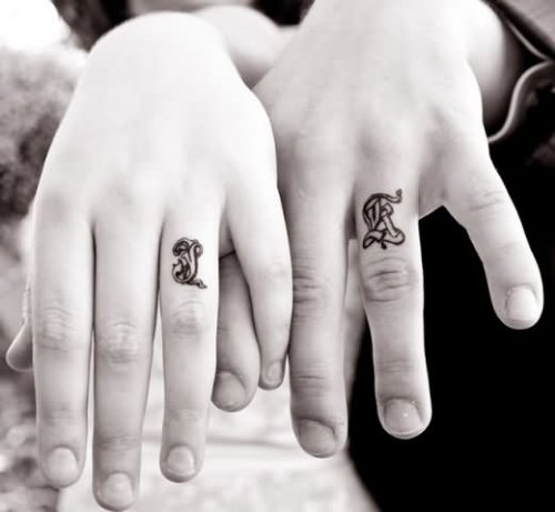 Beautiful Couple Showing Band Tattoos On Fingers